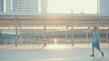 Asyalı iş kadını işe gider, işe gider, gülümser, sırt çantası takar, bisiklet sürer, şehir caddesinde bir bina inşa eder. Bisiklet yolculuğu, bisikletle yolculuk, iş seyahati konsepti..