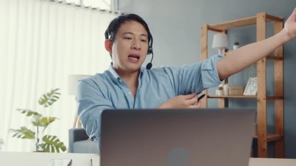 Young Asia Businessman Wear Headphones Using Laptop Talk Colleagues Plan — Stock Video