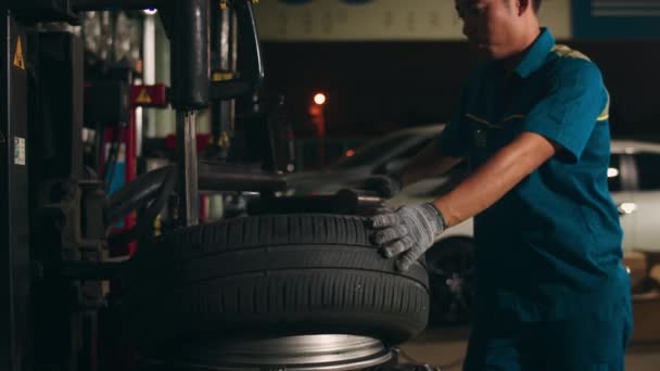 Professional Car Mechanic Changing Car Tire Lifted Automobile Repair Service — Stock Video