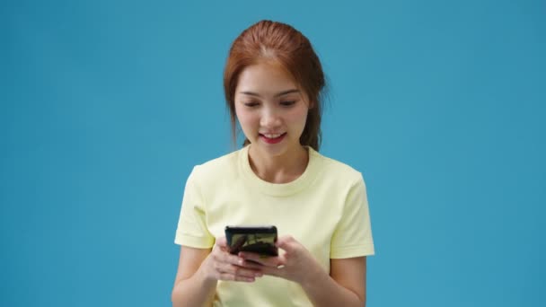 Surprised Young Asia Lady Using Mobile Phone Positive Expression Smiles — Stock Video