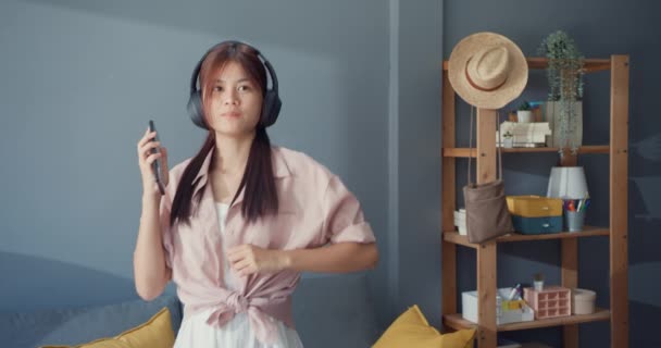 Happy Carefree Young Asia Girl Wear Headphones Listen Music Smartphone — ストック動画