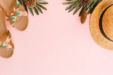 Creative flat lay photo of travel vacation spring or summer tropical fashion. Top view beach accessories on pastel pink color background with blank space for text. Top view copy space photography.