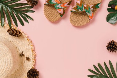 Creative flat lay photo of travel vacation spring or summer tropical fashion. Top view beach accessories on pastel pink color background with blank space for text. Top view copy space photography.