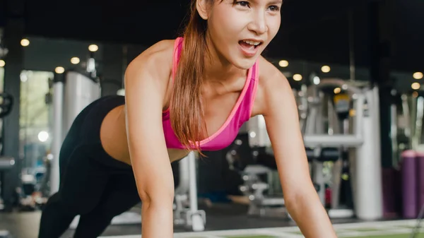 Young Asia lady kickboxing exercise workout punching bag tough female  fighter practice boxing in gym fitness class. Sportswoman recreational  activity, functional training, healthy lifestyle concept. Stock Photo