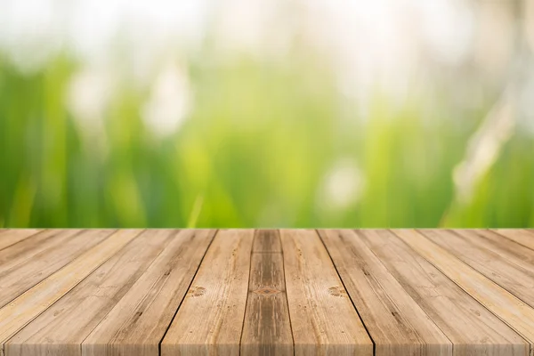 Wooden board empty table blur trees in forest - can be used for display or montage your products. spring season. vintage filtered image. — Stock Photo, Image
