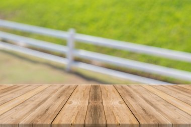 Wooden board empty table in front of blurred background. Perspective brown wood over blur trees in forest - can be used for display or montage your products. spring season.