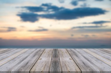 Wooden board empty table in front of sunset background. Perspective wood floor over sea and sky - can be used for display or montage your products. beach & summer concepts.