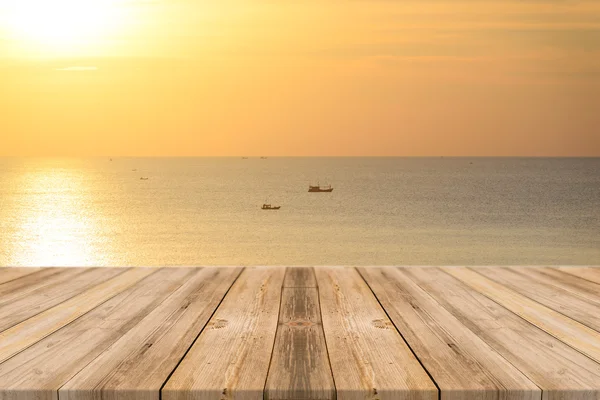 Wooden board empty table in front of sunset background. Perspective wood floor over sea and sky - can be used for display or montage your products. beach & summer concepts.