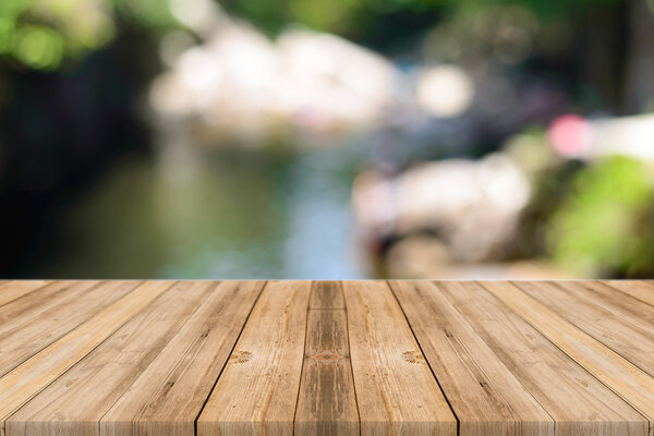 Wooden board empty table in front of blurred background. Perspective grey wood over blur trees in forest - can be used for display or montage your products. spring season.