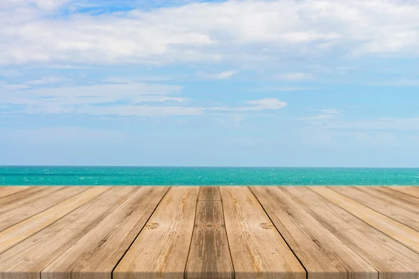 Vintage wooden board empty table in front of blue sea & sky background. Perspective wood floor over sea and sky - can be used for display or montage your products. Stok Fotoğraf