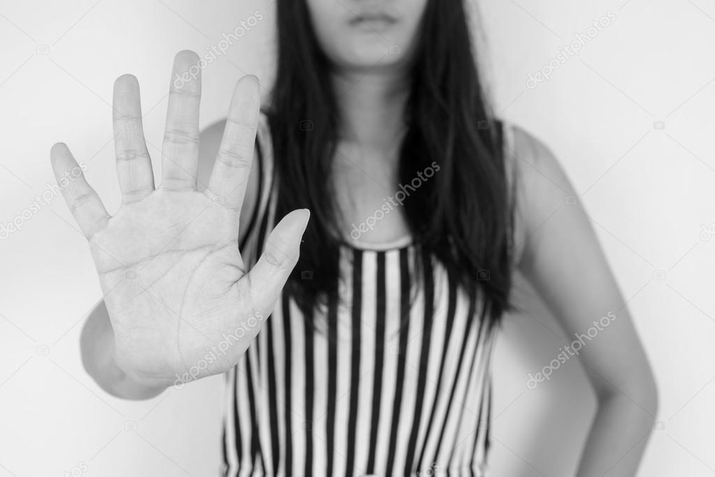 Young woman showing her denial with NO on her hand