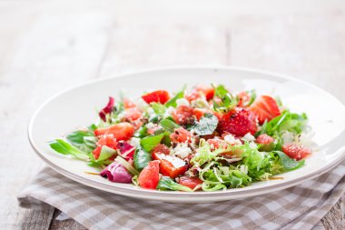 Yaz salatası ile greyfurt, çilek, nane, balsamik ve ahşap zemin, closeup bir plaka üzerinde peynir