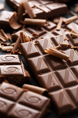 Koyu arka planda kırılmış çikolata. - Yakın çekim. Çikolata arkaplanı 