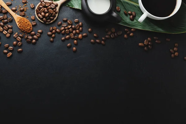 Coffee concept with coffee beans, wooden spoons and coffee espresso in cups. View from above.