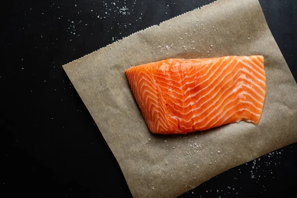 stock image Raw salmon with spices on dark background. Top View 