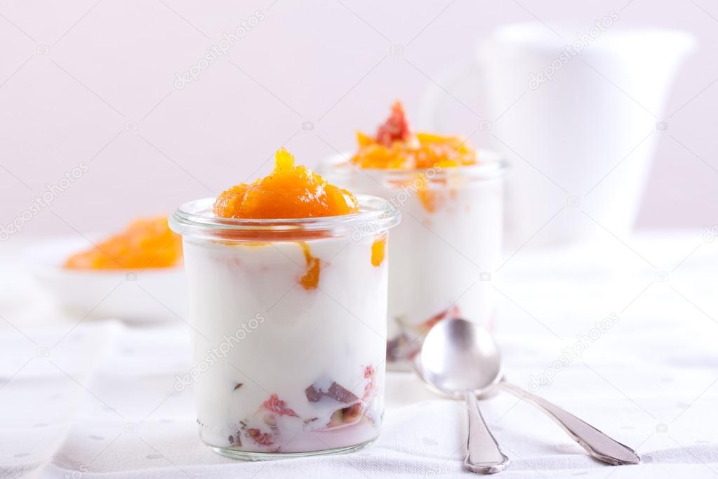 Dessert with pumpkin puree, yogurt and figs on white background