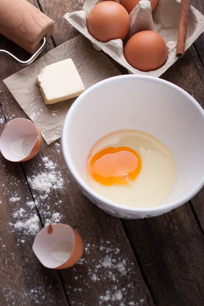 Ingredienti e strumenti pronti per fare una torta, farina, uova, burro, bastoncino di cannella su un tavolo di legno — Foto Stock