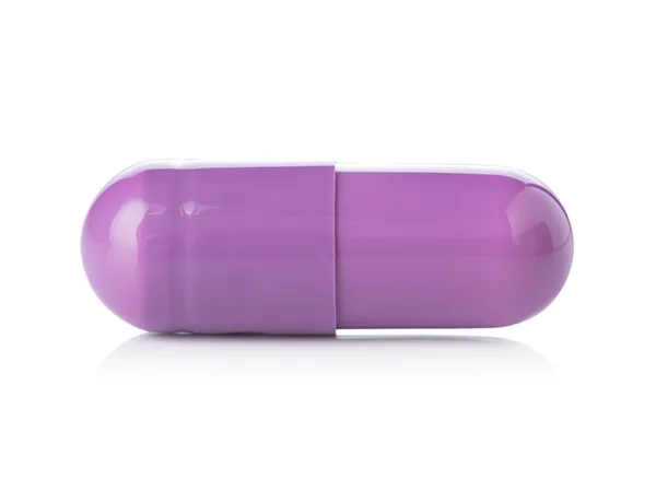 Paarse pil capsules op witte achtergrond — Stockfoto