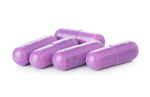 Purple pill capsules on white background — Stock Photo, Image