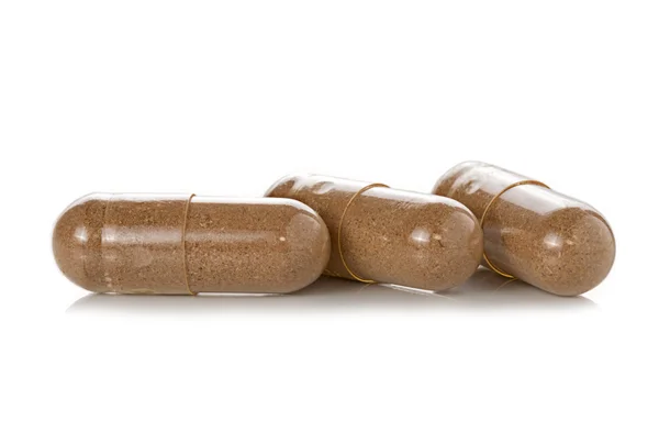 Pílulas de cápsula no fundo branco — Fotografia de Stock