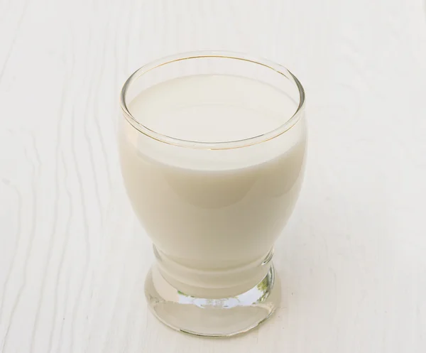 Glass of milk on wood background — Stock Photo, Image