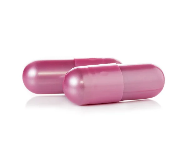 Pink pill capsules on white background — Stock Photo, Image