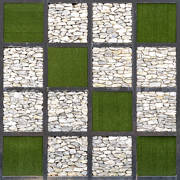 Wall of stone and artificial grass background — Stock Photo, Image