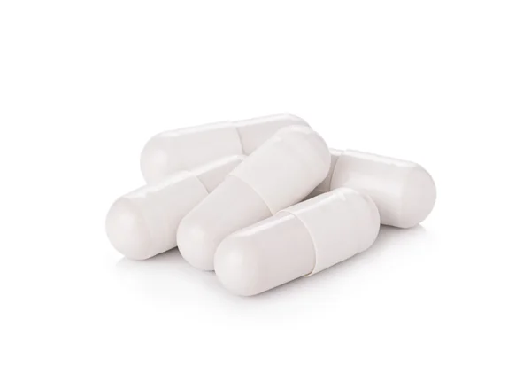 Capsules de pilule blanche sur fond blanc — Photo