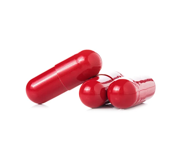 Cápsulas de píldora roja sobre fondo blanco —  Fotos de Stock