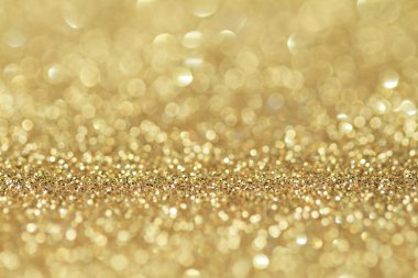 Abstract golden glitter background. Celebration and christmas ba clipart