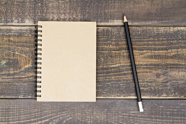 Notebook and pencil on wooden background. — Stock Photo, Image