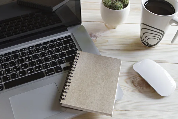 A cup of coffee, laptop computer, mouse, notebook and cactus on — Stock Photo, Image