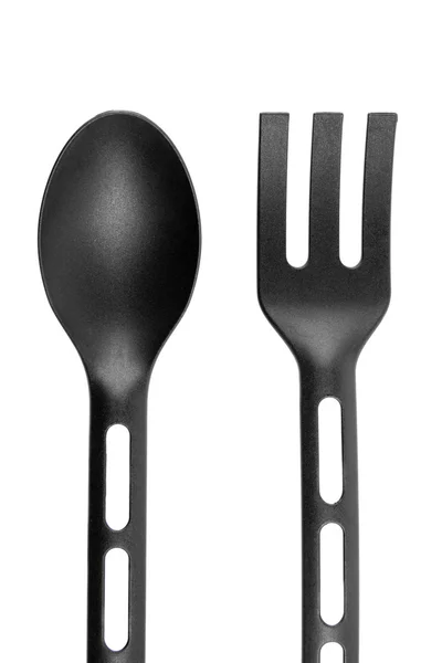 Zwarte lepel en vork op geïsoleerde Wit. — Stockfoto