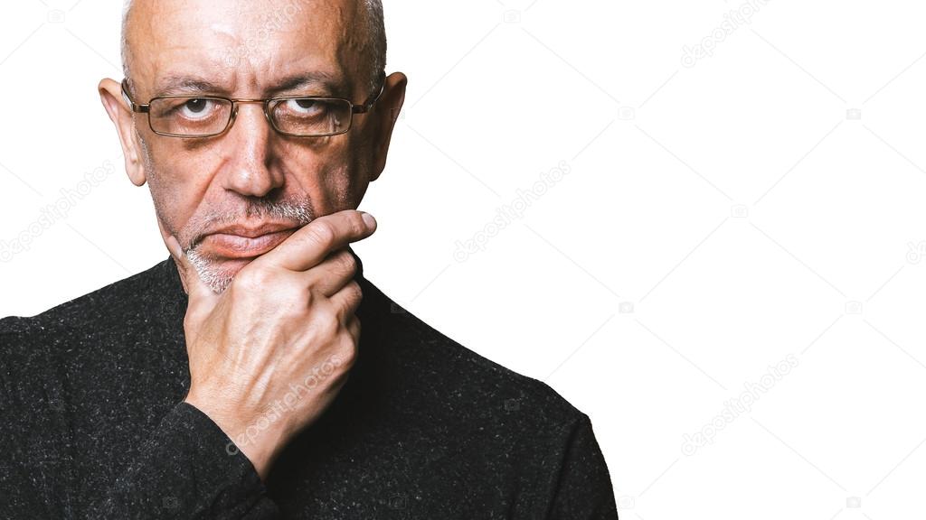 Skeptical senior man looking into the camera isolated on white background with copyspace