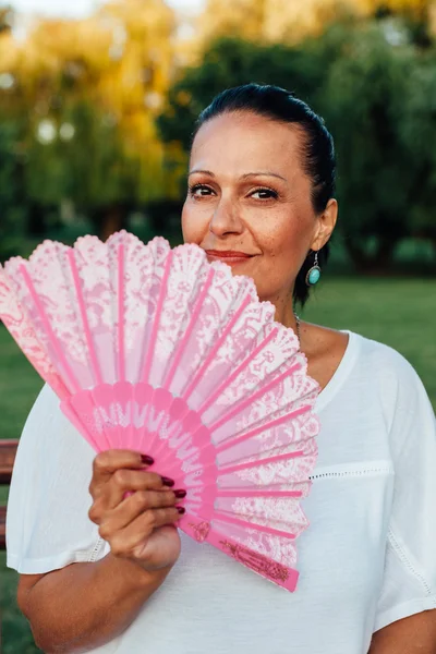 Woman holding hand fan