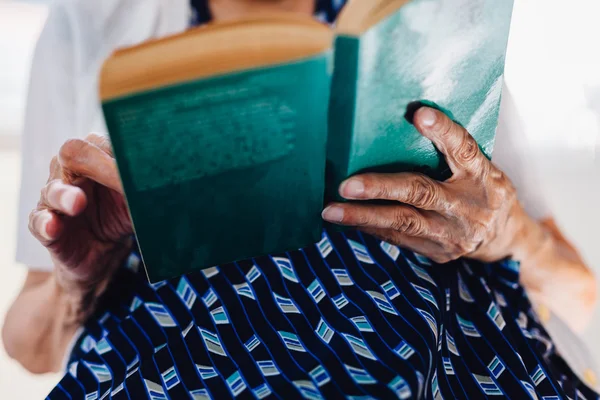 Old woman reading a book