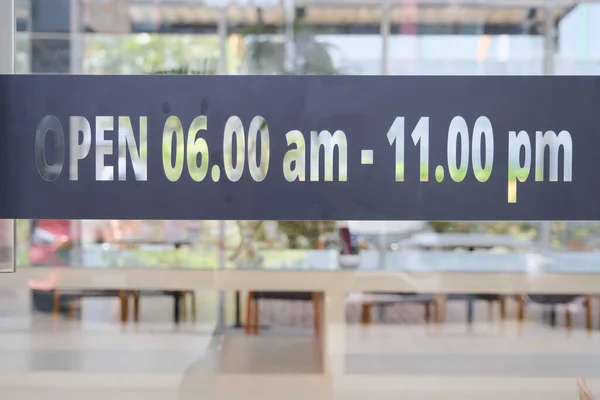 sticker message opening time hours on the glass door or window