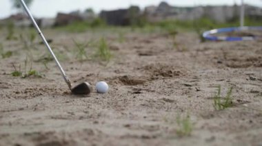 Kumdaki golf sopası.