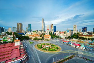 Ho Chi Minh city, Vietnam - June 26, 2015: Impression, colorful, vibrant scene of Asia traffic, dynamic, crowded city with trail on street, Quach Thi Trang roundabout at Ben Thanh market, Vietnam. The market an important symbol of Saigon. clipart