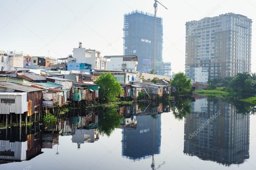 The contrast between slum houses and buildings in Ho Chi Minh city, Vietnam