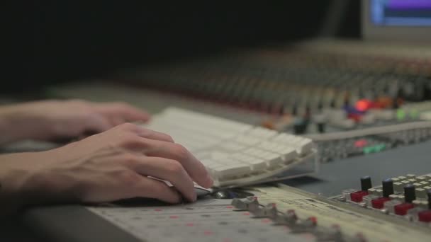 Audio engineer operating mixing console with hands — Stock Video