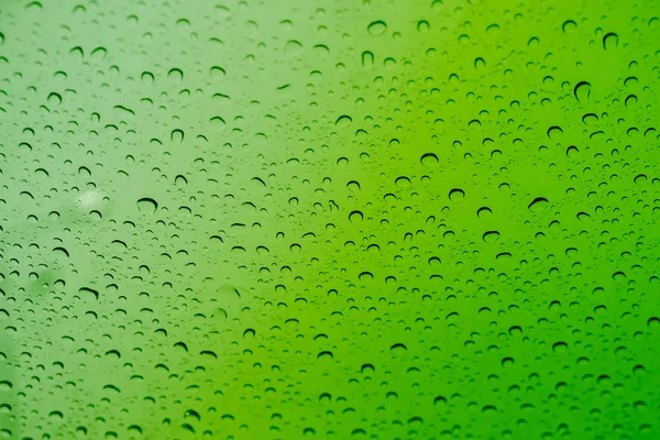 Green water drops on background