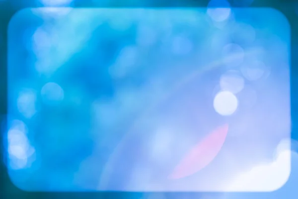 Mavi glitter ışıltı ışınları ışıklar bokeh çerçeve ile defocused