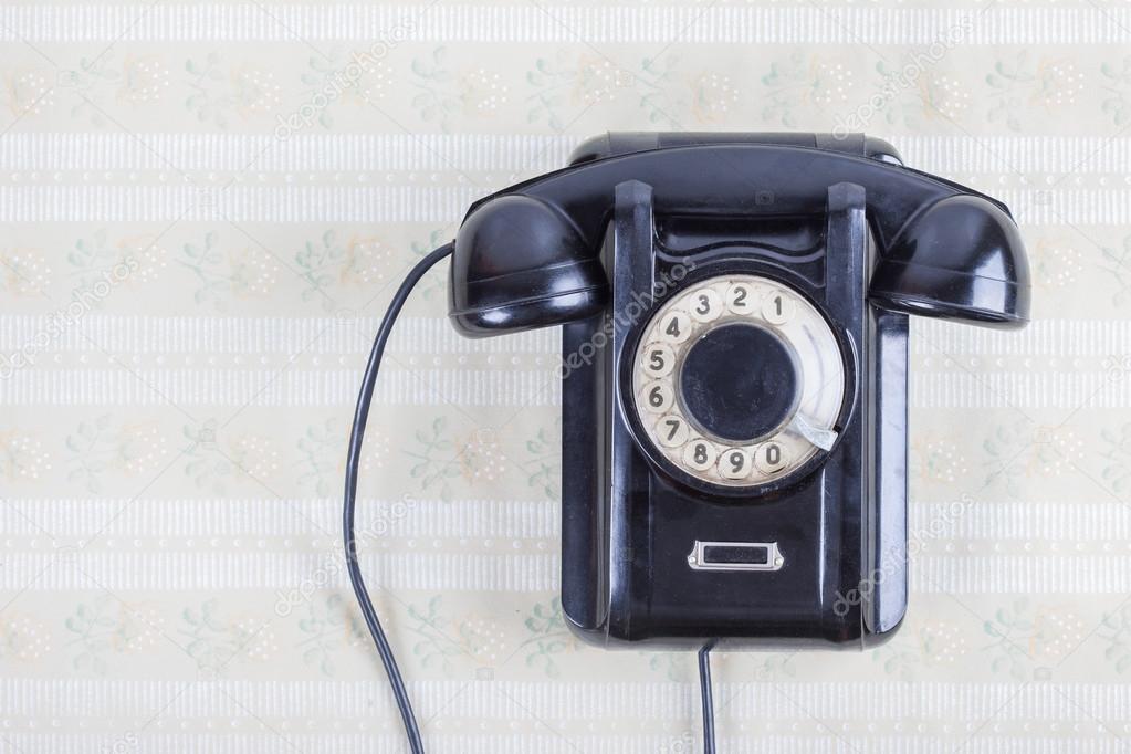 Retro phone on a wooden wall