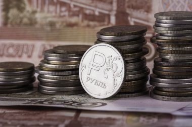 coin ruble on the background of banknotes and money stacks clipart