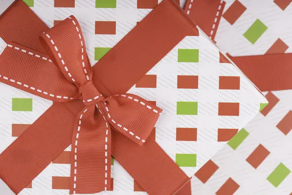 Gift wrapping with a red bow — Stock Photo, Image