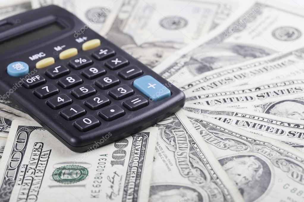 calculator on the background of american dollars banknotes