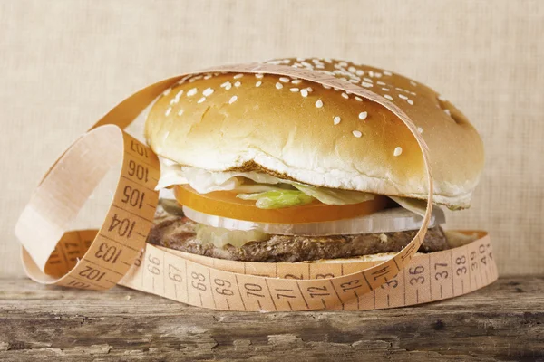 Hamburger with meter diet concept — Stock Photo, Image