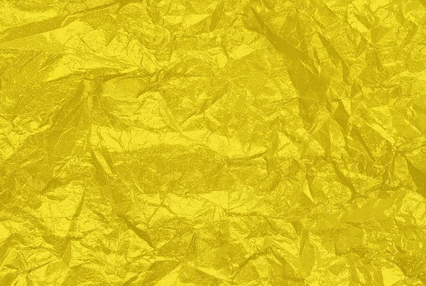 Slavnostní zmačkaná fólie jasně žluté barvy. Vaše pozadí pro design. — Stock fotografie