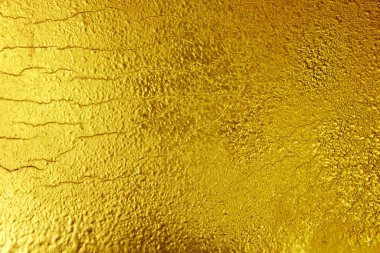 Altın arkaplan dokusu. Altınla boyanmış çatlak doku.